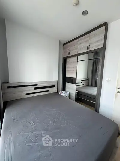 Modern bedroom with sleek wardrobe and stylish bed in a contemporary apartment.