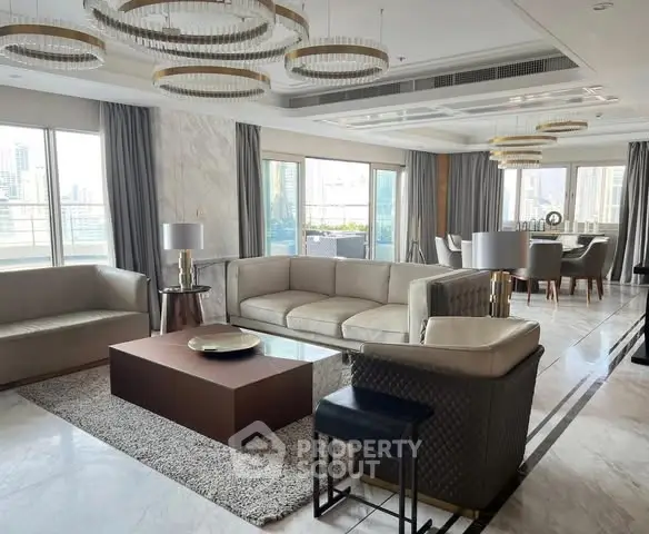 Luxurious living room with modern decor and large windows offering city views.