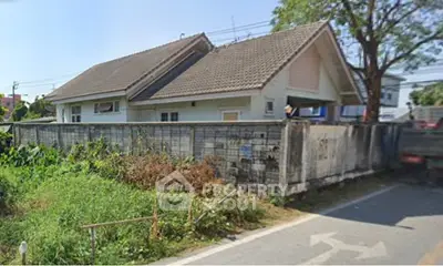 Charming suburban house with sloped roof and lush greenery