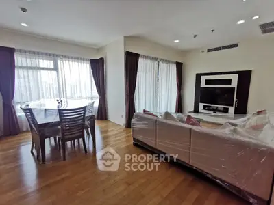 Spacious living room with elegant dining area and large windows