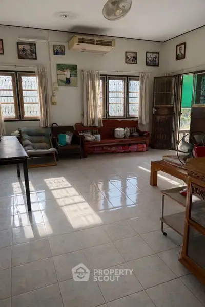 Spacious living room with natural light and traditional decor