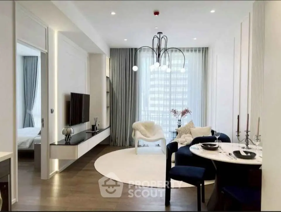 Modern living room with elegant decor and large windows in a stylish apartment.