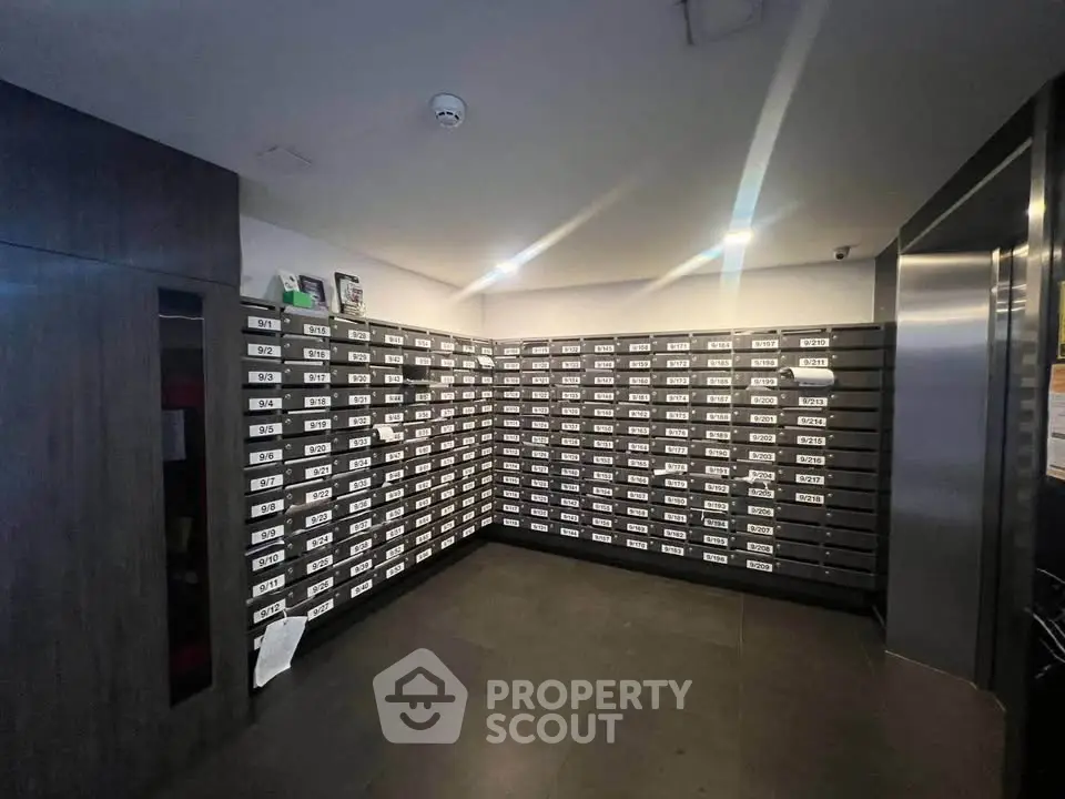 Modern apartment building mailroom with sleek design and organized mailboxes.