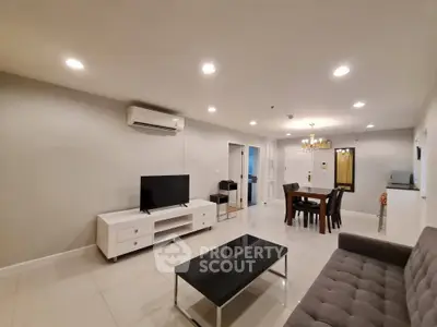 Spacious modern living room with elegant dining area and sleek furniture
