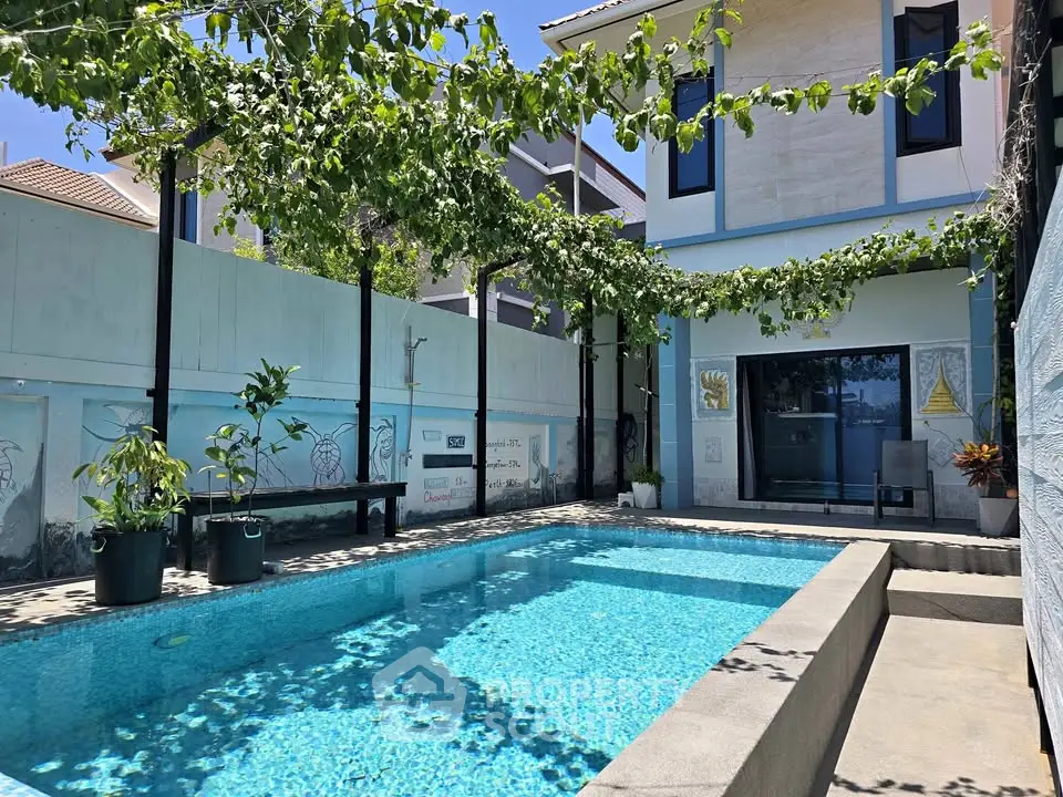 Stunning private pool area with lush greenery and modern architecture, perfect for relaxation and entertainment.