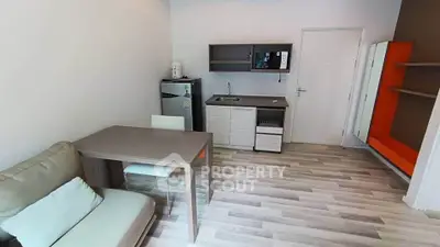 Modern studio apartment with compact kitchen and cozy living area, ideal for urban living.