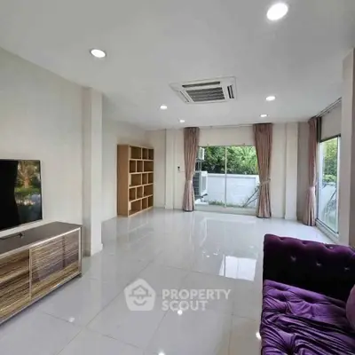 Spacious living room with modern decor and large windows for natural light.