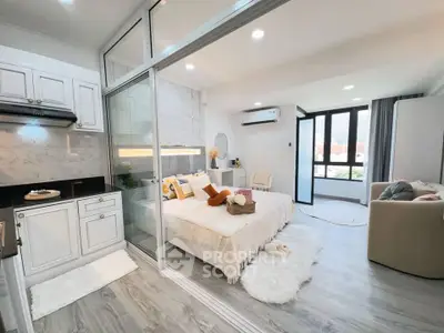 Modern studio apartment with open layout, featuring a cozy bedroom and stylish kitchen area.