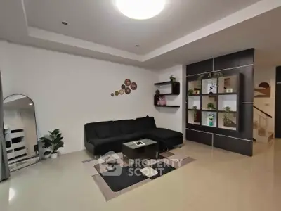 Modern living room with sleek black sofa and stylish decor