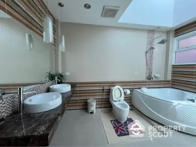 Luxurious bathroom with modern fixtures and elegant design, featuring dual sinks and a spacious bathtub.