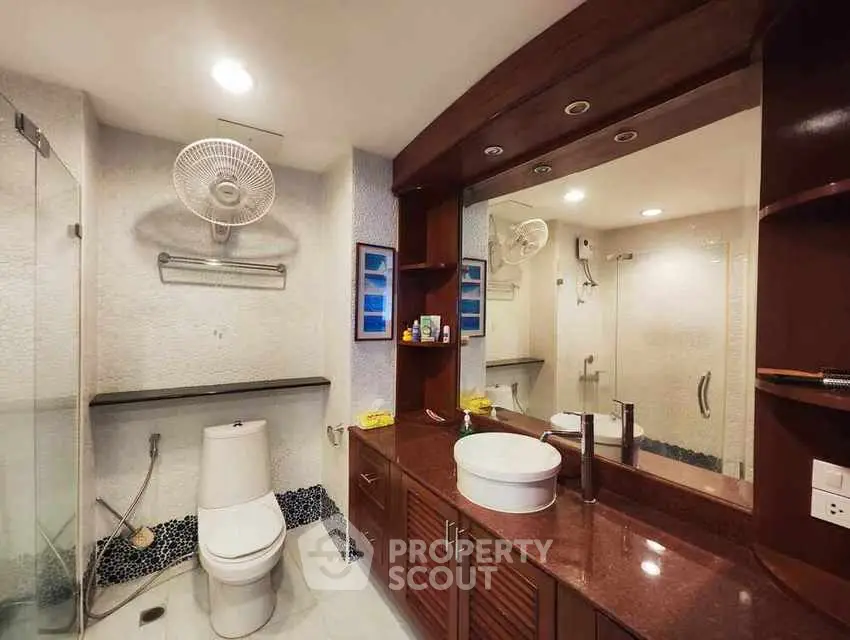 Modern bathroom with elegant wooden cabinetry and large mirror