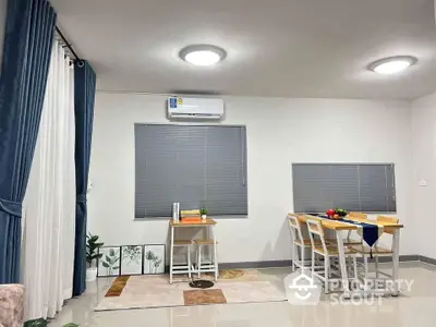 Modern dining area with sleek furniture and bright lighting in a contemporary home.