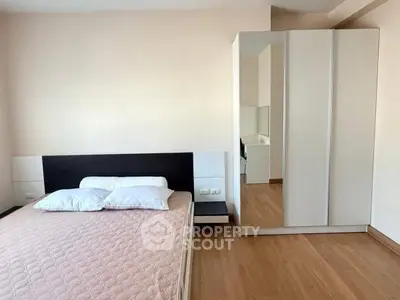 Spacious bedroom with modern wardrobe and cozy bed in minimalist design.