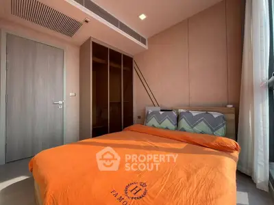 Cozy bedroom with modern design and ample natural light, featuring a comfortable bed and stylish decor.