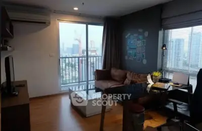 Modern living room with city view, featuring stylish furniture and ample natural light.
