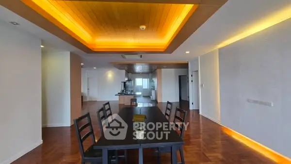 Spacious dining area with modern lighting and wooden flooring