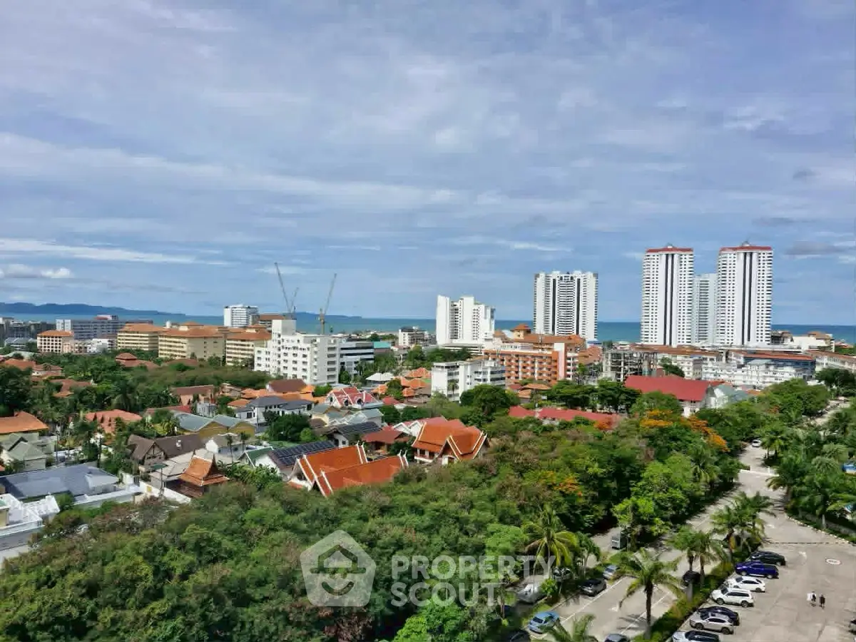 Stunning aerial view of coastal cityscape with high-rise buildings and lush greenery.