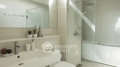 Modern bathroom with sleek fixtures and glass shower enclosure