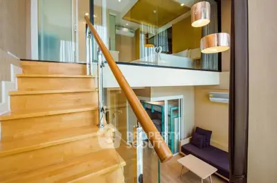 Modern duplex apartment with stylish wooden staircase and cozy living area