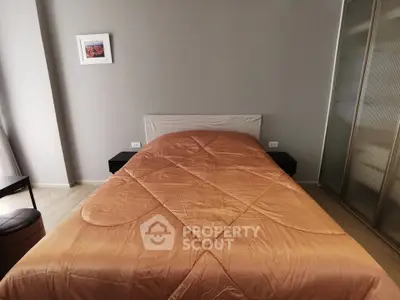 Cozy bedroom with modern decor and comfortable bedding in a stylish apartment.