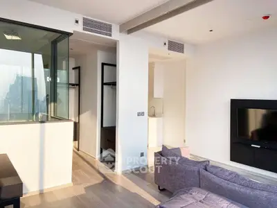 Modern living room with sleek design and large windows offering city views