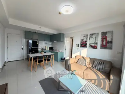 Modern open-layout living room with stylish kitchen and cozy seating area.