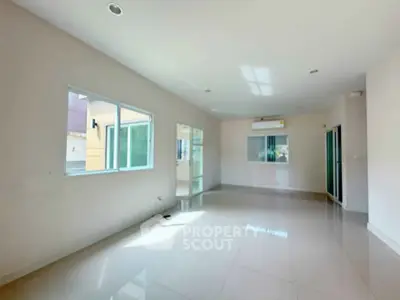 Spacious empty living room with large windows and glossy floor tiles