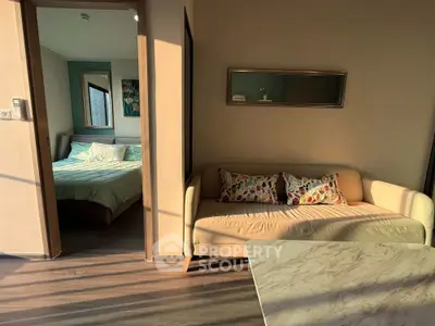 Cozy apartment interior with sunlit living room and adjacent bedroom