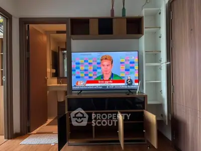 Modern living room with stylish TV stand and open storage cabinets, perfect for entertainment setup.