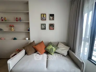 Stylish living room with cozy sofa and decorative pillows, perfect for relaxation and modern living.