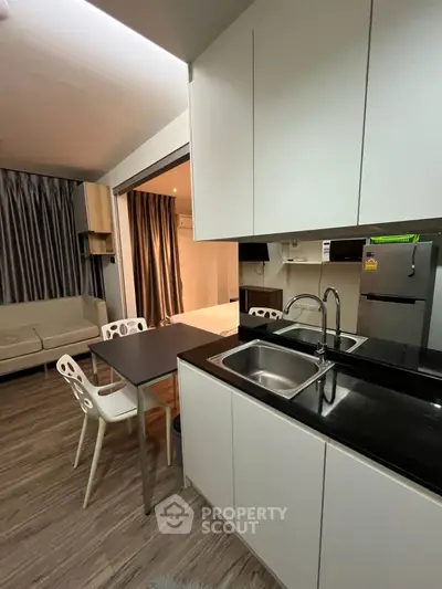 Modern open-layout kitchen with sleek design and cozy living area
