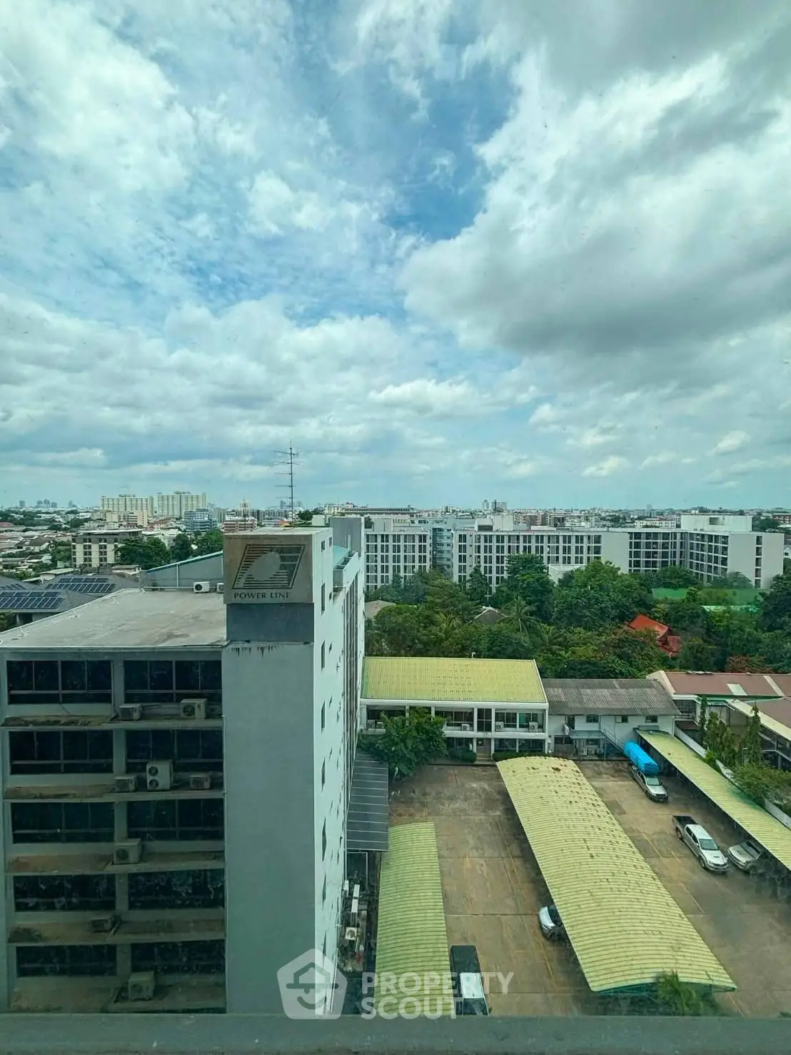 Stunning cityscape view from high-rise building window showcasing urban living and expansive skyline.
