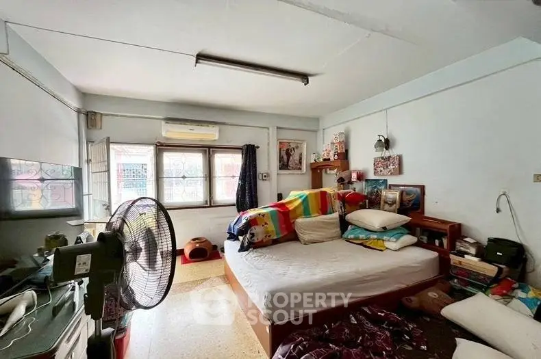 Cozy bedroom with colorful decor and natural light