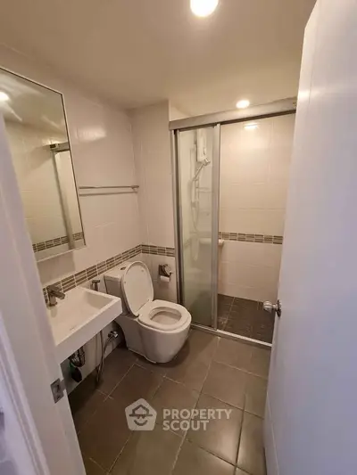 Modern bathroom with glass shower and sleek fixtures