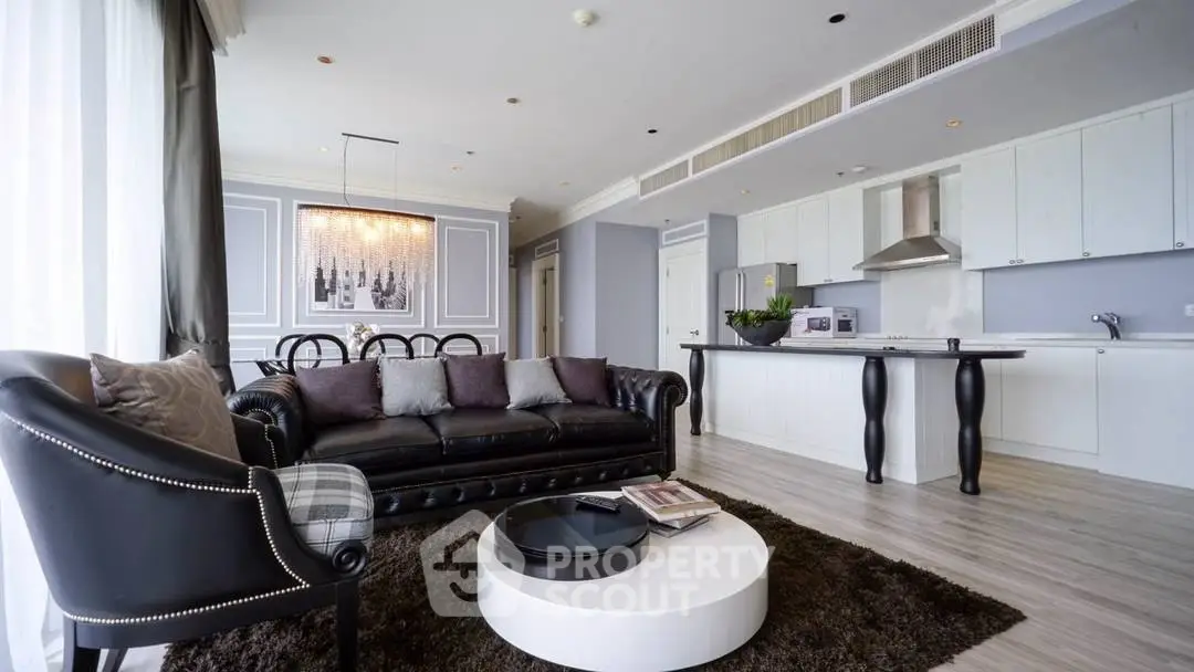 Luxurious open-layout living room with modern kitchen and elegant decor