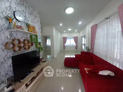 Spacious living room with modern decor and red sofa