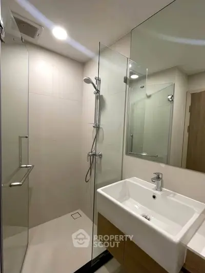 Modern bathroom with glass shower and sleek sink design