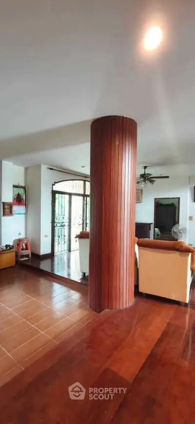 Spacious living room with wooden column and cozy seating area