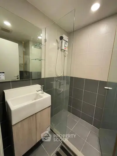 Modern bathroom with glass shower and sleek sink design