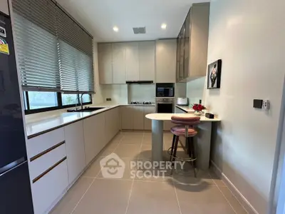 Modern kitchen with sleek cabinetry and breakfast bar in stylish apartment
