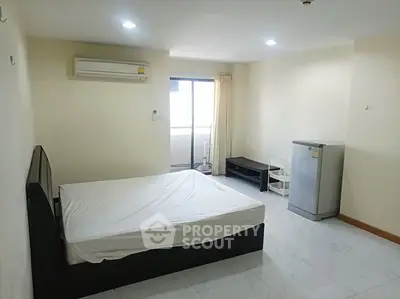 Spacious bedroom with air conditioning and balcony access