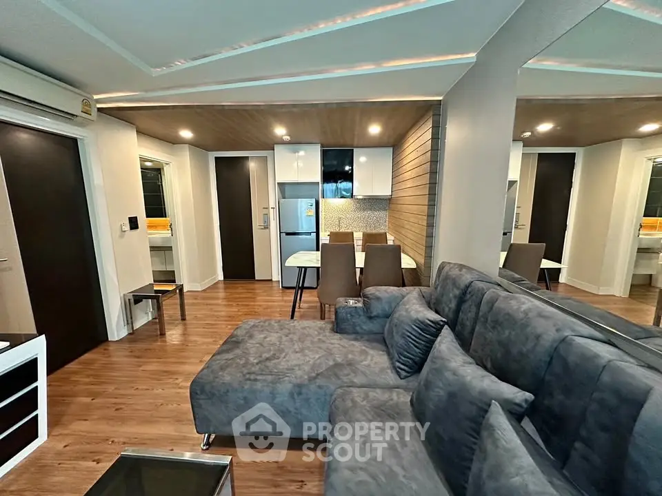 Modern living room with sleek furniture and open kitchen layout in stylish apartment