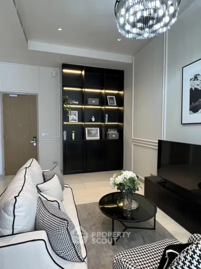 Elegant living room with modern decor, black shelving, and stylish lighting.