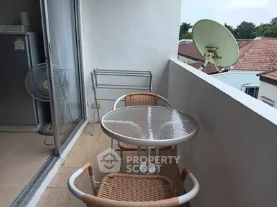 Charming balcony with outdoor seating and satellite dish, perfect for relaxation and enjoying views.