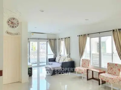 Bright and spacious living room with modern decor and large windows for natural light.