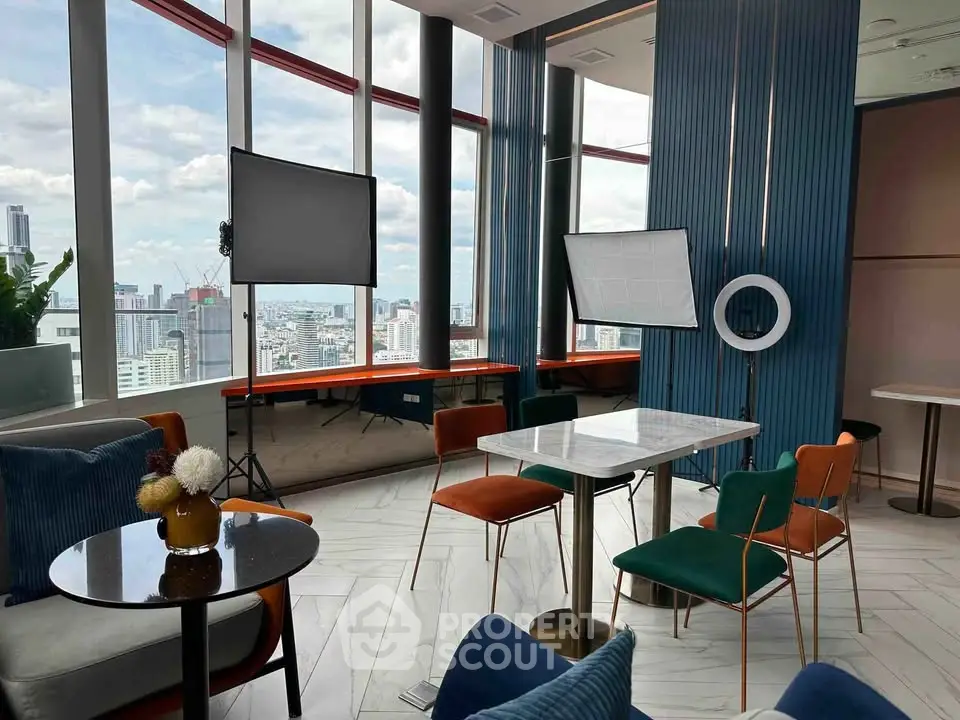 Modern high-rise building interior with panoramic city views and stylish furniture.