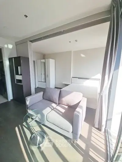 Modern living room with sleek sofa and glass table in bright apartment