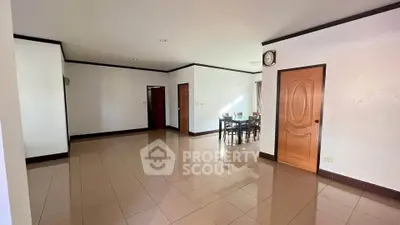Spacious open-plan living area with dining space and tiled flooring