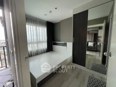 Modern bedroom with large window and mirrored wardrobe in a stylish apartment