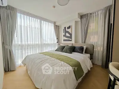 Bright and modern bedroom with large windows and stylish decor in a contemporary apartment.